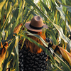 Woman standing in corn field in fall